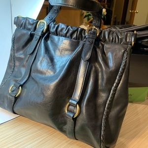 Black leather tote bag with gold hardware.